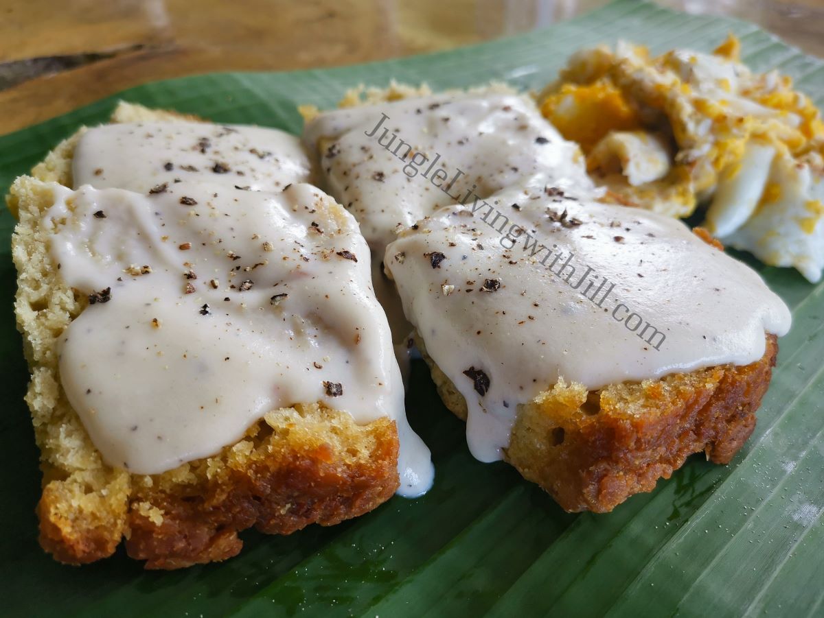 Butter swim sourdough biscuits & gravy with eggs on banana leaf